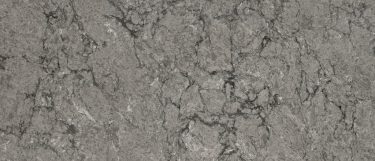 a Fantasy Gray quartz countertop surface that features deep shades of gray with dark veining and cloudy white details