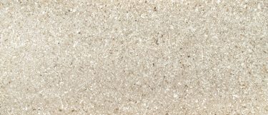 a Chakra Beige quartz countertop surface that features specks and veins in beige, ray, and white over the tan background