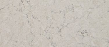 a Carrara Mist quartz countertop surface that features subtle specks and vein details over the creamy background