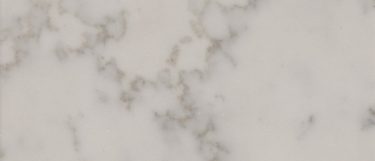 a Carrara Grigio quartz countertop surface that features soft gold clouds and vein details over the warm white background