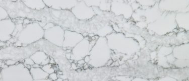 a Calacatta Naples quartz countertop surface that features long soft veins in gray over the white background