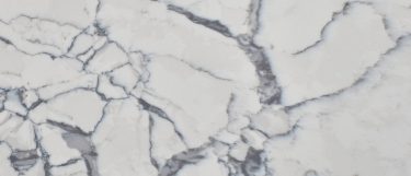 a Calacatta Lago quartz countertop surface that features rich gray veining over the grayish white background