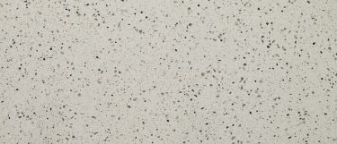a Bianco Pepper quartz countertop surface that features flecks of gray, greige, and brown speckled throughout the white background