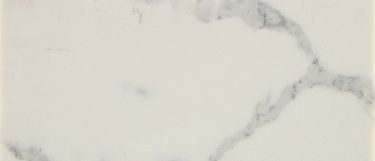 a Qrtz Wht Atatua quartz countertop surface that has a white base with gray veining