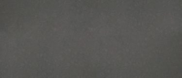 a molten grey quartz countertop surface that has subtle speckles over the mid-tone gray background