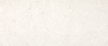a Kodiak quartz countertop surface that has a creamy white background with subtle veining design