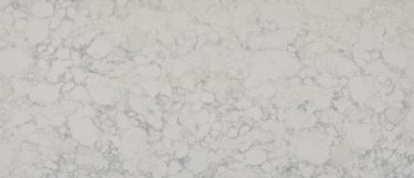 a Geyser quartz countertop surface that has a gray design over the white background