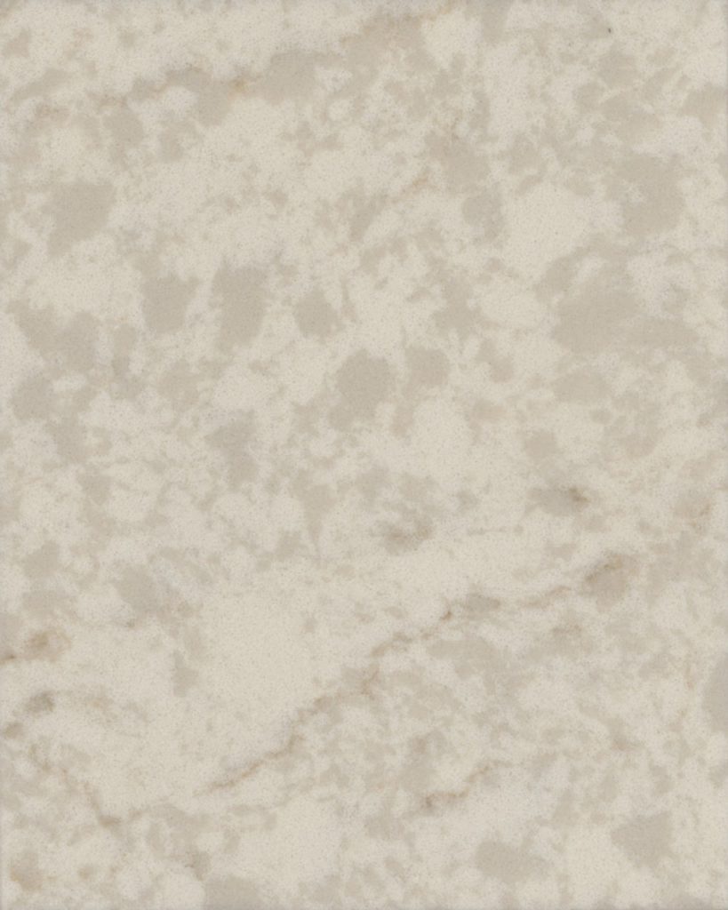 a Cararra Aura quartz countertop surface that features white and cream tones with gray striation details