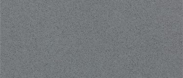 a Brushed Flannel quartz countertop surface that has a gray color with black spot details that creates a grainy texture