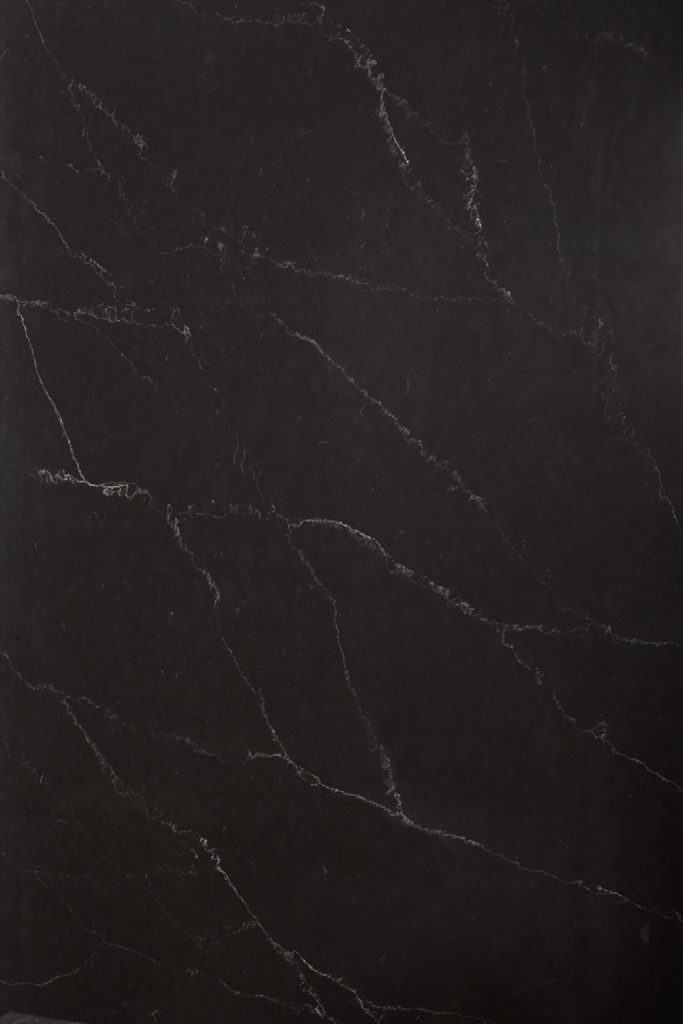 a Broadway Black quartz countertop surface that features long delicate veining details in white over the dramatic deep black background