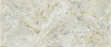 an Almondine quartz countertop surface that features an ash gray color with warm cream, beige, and speckles of gray over the white background