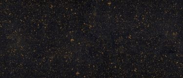 a welshpool black quartz countertop surface that has a black base flecked with tan and gray specks