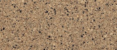 a victoria quartz countertop surface that has tan and cream tones with black specks