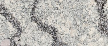 a Seagrove quartz countertop surface that has thick gray veins in various tones of gray specks over the cream background