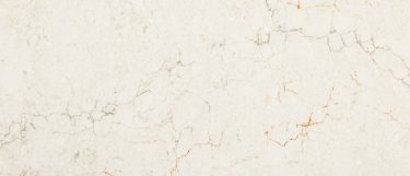 a ridgegate quartz countertop surface that has gray and rusty veining pattern over the creamy white background