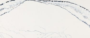 a Portrush quartz countertop surface that features veining patterns in gray, navy blue, and black over the creamy white base