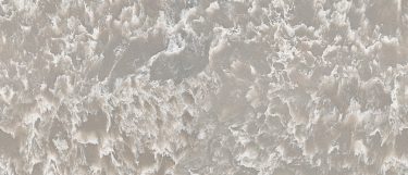 a Myddleton quartz countertop surface that has white swirling pattern over the mauve-gray base