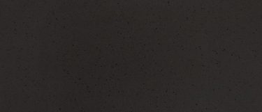 a Montana Midnight quartz countertop surface that has a charcoal gray color that is sprinkled with tiny black dots and ink spots