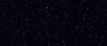 a Menai quartz countertop surface that features deep black background with silver sparkles