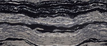 a Levven quartz countertop surface that features dynamic waves in colors black and gray with hints of white