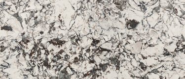 a Huntley quartz countertop suface that has a swirling design in brown and gray over the white base