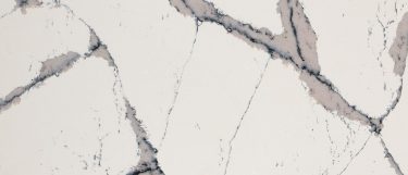 a Harrogate quartz countertop surface that features black and dark gray veins over the pale creamy base