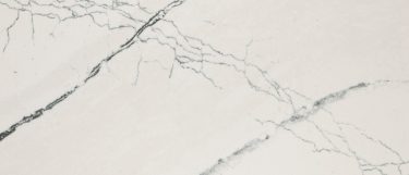 a Gladstone quartz countertop surface that features thin veins over the light gray background