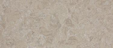 a Buxton quartz countertop surface that features a grainy concrete foundation with white speckles and gray and cream details