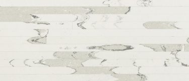 a Brittanicca Block quartz countertop surface that has blocks and parallel lines in cream tones