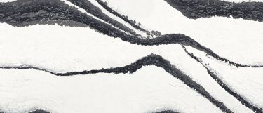 a Bentley quartz countertop surface that features bold veins in black and charcoal with light gray spatters over the white background