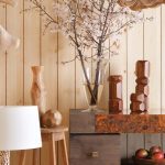 neutral color decorative flower vases, displays, and Aberdeen counter against the wood paneled wall surface