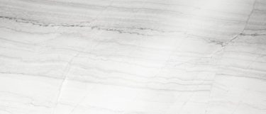 a white macaubas granite countertop with veins of charcoal over its white base.