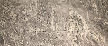 a waterfall granite countertop surface that blends beige and gray all over its surface in swirling pattern