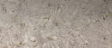 a Blanco Gabriele granite countertop surface that features flecks of silver and gray over the creamy white background