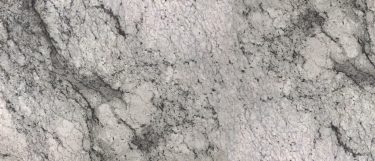 a white lava granite countertop that blends shades of white, gray, taupe, and black over its white surface