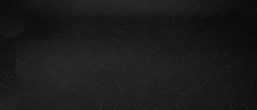 a star galaxy granite countertop surface that has a black base with gold and copper flecks
