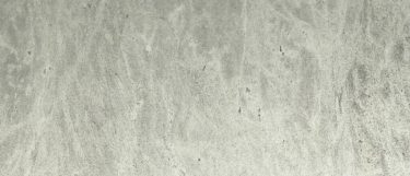 a silver silk granite countertop surface that has a soft design in charcoal and white tones