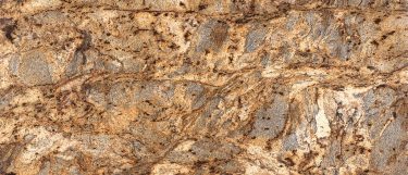 a Lapidus granite countertop surface that has a dominant brown color with rich golds and small flecks in grays and creams
