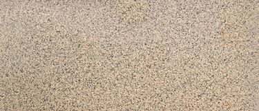 an Iberia Sunset granite countertop surface that golden beige color with specks of brown and gray