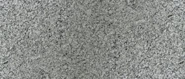 a Dawn Mist granite countertop that has colors of charcoal, black, white, and cream blended into its surface