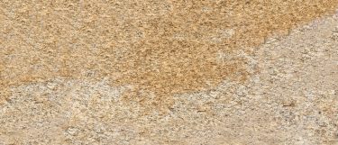 an Amarillo Santa Cecilia granite countertop surface that features the blend of brown and beige shades with its dominant yellow color
