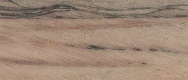 a wild sea granite countertop that has shades of sandy browns with black ang green wavy and linear veining
