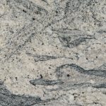 a white wave granite countertop that has dark veins over the light gray background