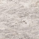 a stone countertop surface with delicate gray veining over the beige base