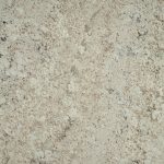 a white supreme granite countertop surface with swirls and veins in gray and white that flow over the creamy white background