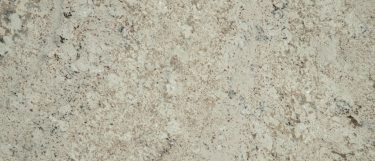 a white supreme granite countertop surface with swirls and veins in gray and white that flow over the creamy white background