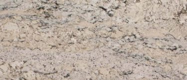 a white ice granite countertop surface with a cool white base with flecks of gray, white, and black
