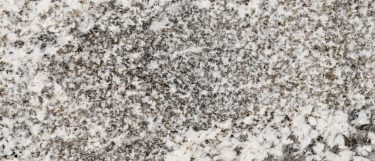 a whisper white granite countertop surface that features striking black veins against a cool white background