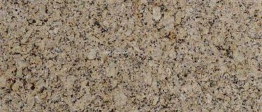 a venetian ice countertop surface that blends various cream colors, fawn, and beige with black spots on its surface