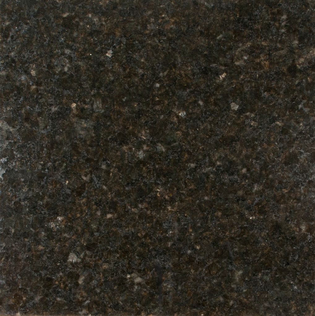 an ubatuba granite countertop surface that features black, gold, gray, and green speckles over its dark green base